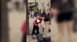 A young street musician sings the song "My Heart Will Go On"