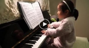 A 5-year-old girl plays the piano beautifully