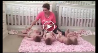 The mother spread out the quadruplets and began to dress them