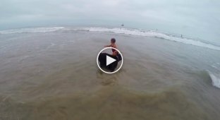 The dog does not let his little owner near the big waves