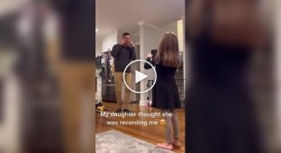 The girl thinks she is filming her dad
