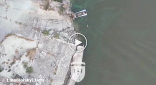 Occupiers, bleeding, swim around their boat after drops from a Ukrainian drone