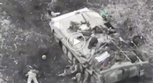 Liquidated occupiers lie around their destroyed BMP