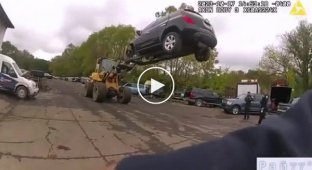 Auto repair shop employees using a forklift to catch a thief