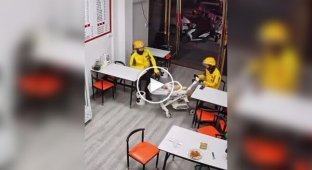 Cafe visitors babysit a worker's child while she makes them takeaway food.
