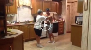 Mom and son dance in the kitchen