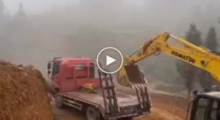 This is how the loading of construction equipment onto a cargo platform looks like
