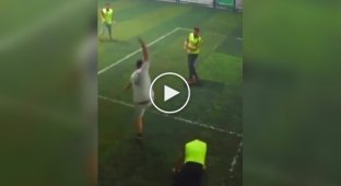 Mini-football fans try to kick the ball into the goal