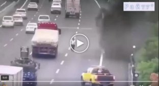 A policeman, running past a burning truck, miraculously escaped being burned in China.