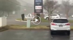 An American woman was almost blown away by a tornado, which she filmed on camera