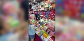 A girl popped all the balloons at a shooting range without missing