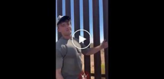 A man is trying to check how easy it is to cross the wall on the US-Mexico border