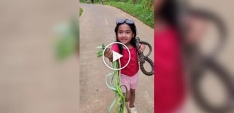 In Indonesia, a girl plays with snakes instead of dolls