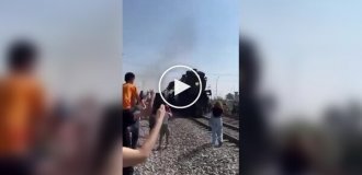 The train knocked the smartphone out of the girl's hands