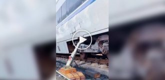 Lifting a derailed train car with a powerful jack