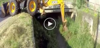 Acrobat backhoe loader and cleaning a canal