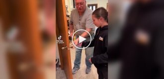 Grandfather pulls out baby tooth for granddaughter