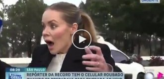Brazil: thief on bicycle steals reporter's phone live on air