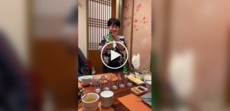 Cocktail as an attraction: a woman entertains clients of the establishment
