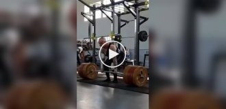 Girl and a barbell weighing 210 kilograms