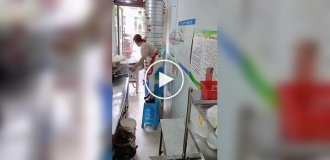 A diner owner lifts 24 tiers of steamed buns at a time.