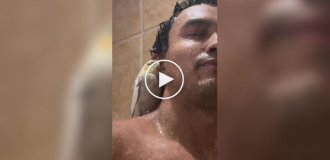 A parrot takes a shower with its owner