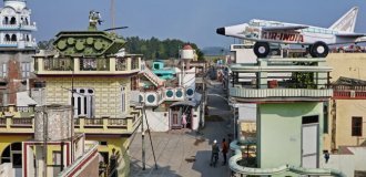 Why are there tanks, planes and elephants on the roofs of this village (8 photos)