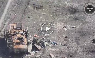 A Ukrainian FPV drone shot down two Russians near a destroyed armored personnel carrier somewhere in the east