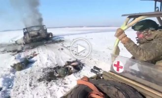 Occupiers inspect a loaf of bread burning after a drone attack