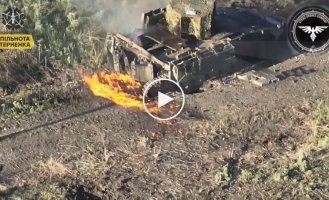 An enemy infantry fighting vehicle that runs over a mine is set on fire by a kamikaze drone