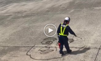 Japanese airport employee draws street art for passengers with water