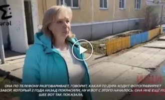 Russian woman snitched on a neighbor for the color of the fence in yellow and blue