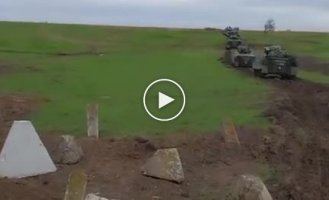 A column of Ukrainian Marder infantry fighting vehicles delivered from Germany is practicing dragon-tooth-crossing maneuvers at a training ground