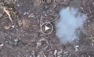 An occupier's leg and helmet fly in the air after a grenade is dropped from a Ukrainian drone