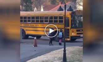 A dog walks girls to the bus