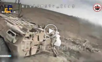 Two occupiers with white bags on their shoulders run before dying around a damaged armored vehicle, trying to escape from the drone