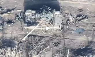 Two dozen liquidated occupiers lie near a damaged tank on the road near Avdeevka