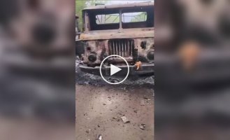 The occupier films a Russian army truck burned by a Ukrainian drone and a pile of remains of its driver