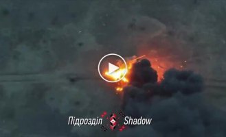 Two Russian armored vehicles are on fire on the battlefield