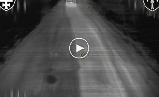 A kamikaze drone flies into the back of a truck in which three occupiers are sitting