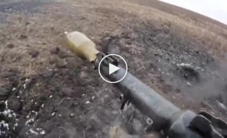 Ukrainian soldiers use an RPG to finish off a Russian tank that ran into a mine in the Donetsk region.