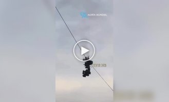 Suspended camera It caught fire and fell onto a football field.