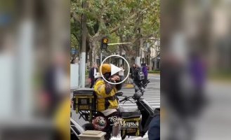 A courier from Shanghai plays the flute between orders, inspiring passers-by