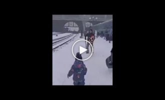 A little girl meets her wounded father at the Lviv train station to the sound of air raid sirens