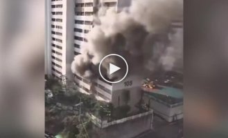 A mad Korean set fire to a high-rise building with a flamethrower, forcing residents to jump out of windows