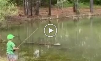 A young and lucky fisherman caught his first big fish