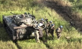 Ukrainian T-80BV tank supports the advance of BMP-2 infantry