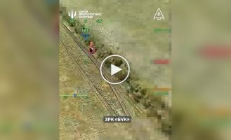 A missile from the Russian A Buk air defense missile system bounces across a forest belt after being hit by a Ukrainian drone