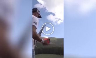 A guy throws twelve targets into the air and manages to hit each of them