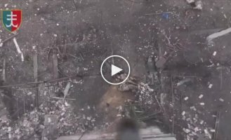 A Russian soldier kicks a grenade dropped from a drone in the Kherson region